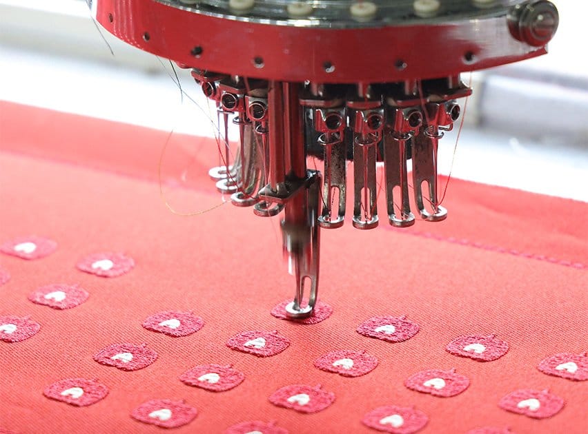 Industrial Tajima machines producing custom hat patches